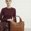 Bolso sofisticado con tachuelas metálicas camel
