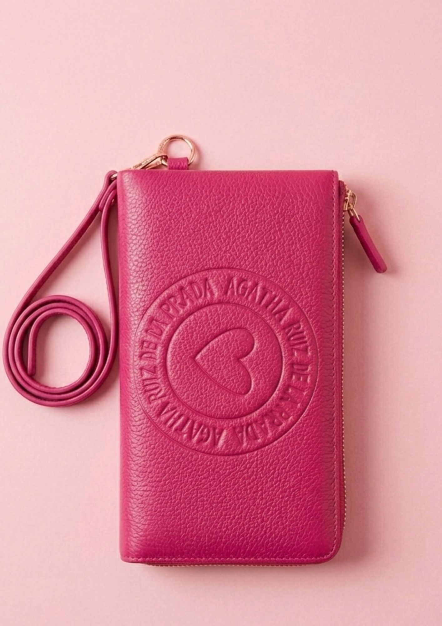 Cartera fucsia con muñequera y diseño elegante. Cartera de mano Agatha Ruiz de la Prada de piel sintética lisa.